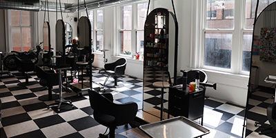 Hair chairs with mirrors in front of them